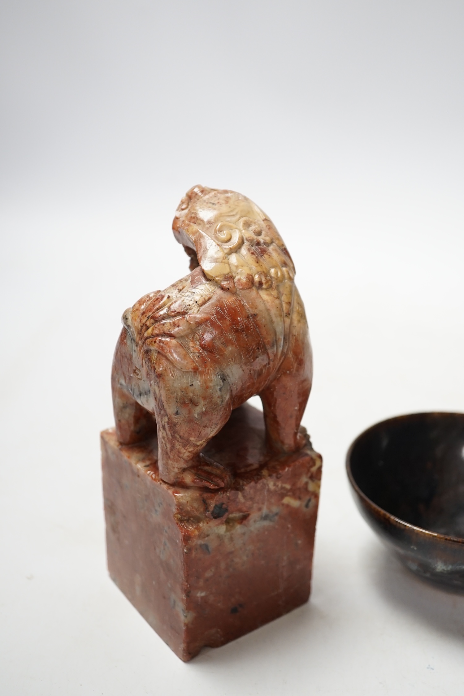 A large Chinese carved soapstone ‘lion dog’ seal and a ‘hares fur’ bowl, largest 17cm. Condition - fair